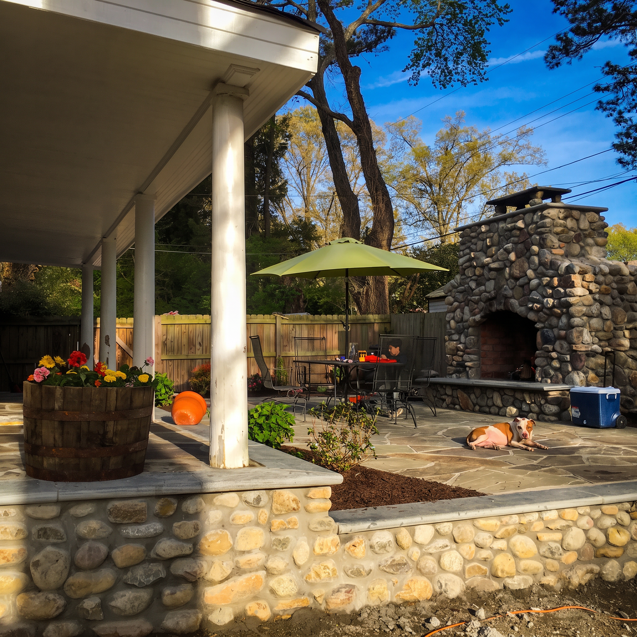 River rock outdoor fireplace on a flagstone patio